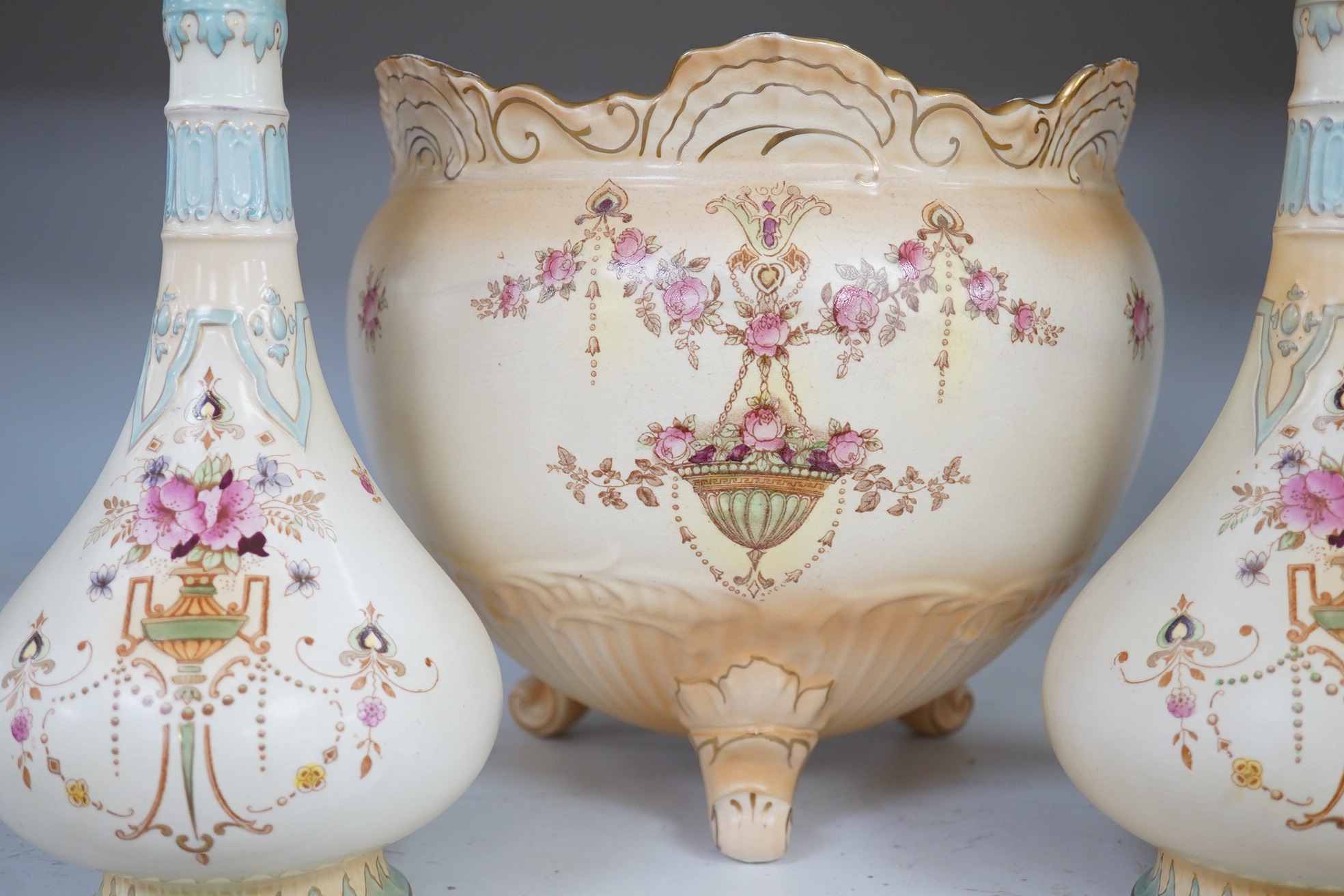 A Crown Devon jardiniere, 23cm high, and a pair of vases, 25.5cm high. Condition - fair to good